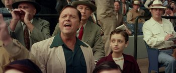 Movie still from “42” (2013), directed by Brian Helgeland – A group of people standing in a crowd of people; Medium shot, Low angle