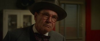 Movie still from “42” (2013), directed by Brian Helgeland – An older man wearing a hat and glasses; Close Up shot, Over the shoulder angle