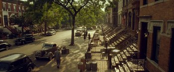 Movie still from “42” (2013), directed by Brian Helgeland – People walking down the sidewalk of a city street; Extreme Wide shot, High angle