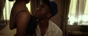 Movie still from “42” (2013), directed by Brian Helgeland – A man in a baseball cap looking up at the ceiling; Close Up shot, Over the shoulder angle