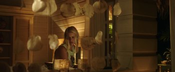 Movie still from “47 Meters Down” (2017), directed by Johannes Roberts – A woman sitting at a table in front of a window; Medium shot, Low angle