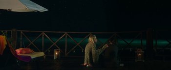 Movie still from “47 Meters Down” (2017), directed by Johannes Roberts – Two people sitting on a dock at night; Wide shot, High angle