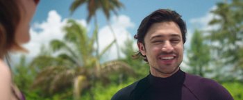 Movie still from “47 Meters Down” (2017), directed by Johannes Roberts – A person wearing a wetsuit smiling; Close Up shot, Low angle