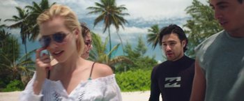 Movie still from “47 Meters Down” (2017), directed by Johannes Roberts – A group of people standing on top of a sandy beach; Medium shot, Over the shoulder angle