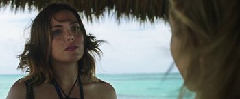 Movie still from “47 Meters Down” (2017), directed by Johannes Roberts – A woman standing under an umbrella near the ocean; Close Up shot, Low angle