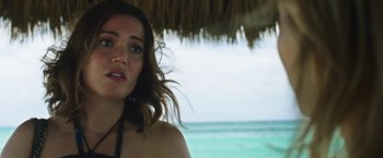 Movie still from “47 Meters Down” (2017), directed by Johannes Roberts – A person under an umbrella near the ocean; Close Up shot, Over the shoulder angle