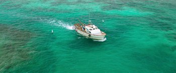 Movie still from “47 Meters Down” (2017), directed by Johannes Roberts – A small boat in the middle of the ocean; Extreme Wide shot, High angle
