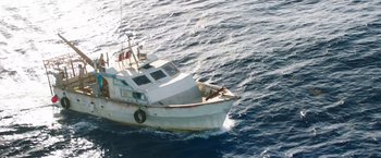 Movie still from “47 Meters Down” (2017), directed by Johannes Roberts – An old white boat in the middle of the ocean; Extreme Wide shot, Overhead angle