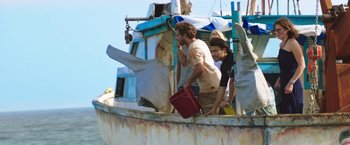 Movie still from “47 Meters Down” (2017), directed by Johannes Roberts – A group of men standing on top of a boat; Medium shot, Low angle