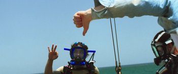 Movie still from “47 Meters Down” (2017), directed by Johannes Roberts – A man in a scuba mask giving a thumbs down sign; Medium shot, High angle