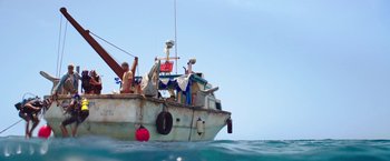 Movie still from “47 Meters Down” (2017), directed by Johannes Roberts – A man is sitting on a boat in the ocean; Wide shot, Low angle