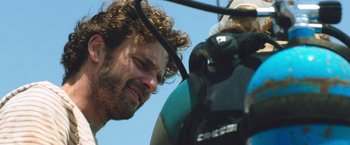 Movie still from “47 Meters Down” (2017), directed by Johannes Roberts – A person looking at a camera; Close Up shot, Over the shoulder angle