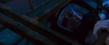 Movie still from “47 Meters Down” (2017), directed by Johannes Roberts – A person is reflected in a mirror in a dark room; Close Up shot, Overhead angle