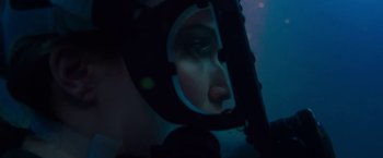 Movie still from “47 Meters Down” (2017), directed by Johannes Roberts – A woman looking into a mirror in a dark room; Close Up shot, Over the shoulder angle