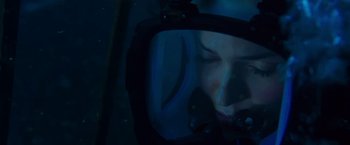 Movie still from “47 Meters Down” (2017), directed by Johannes Roberts – A woman is reflected in the mirror of a diving helmet; Close Up shot, Overhead angle