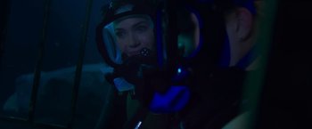 Movie still from “47 Meters Down” (2017), directed by Johannes Roberts – A woman in a scuba diving suit in the dark; Close Up shot, Over the shoulder angle