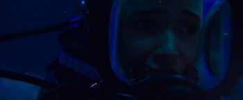 Movie still from “47 Meters Down” (2017), directed by Johannes Roberts – A person wearing a helmet in a dark room; Close Up shot, Overhead angle