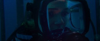Movie still from “47 Meters Down” (2017), directed by Johannes Roberts – A person in a space suit in the dark; Close Up shot, Over the shoulder angle