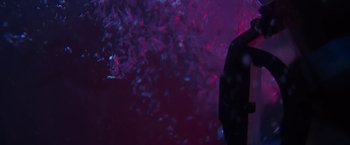 Movie still from “47 Meters Down” (2017), directed by Johannes Roberts – A man standing in front of a tree with purple lights; Medium shot, Low angle