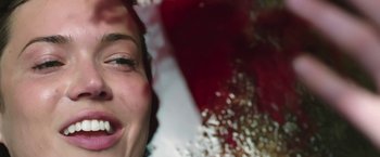 Movie still from “47 Meters Down” (2017), directed by Johannes Roberts – A woman's face with a red background; Extreme Close Up shot, Overhead angle