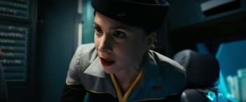 Movie still from “7500” (2019), directed by Patrick Vollrath – A woman with a hat on looking at the camera; Close Up shot, Low angle