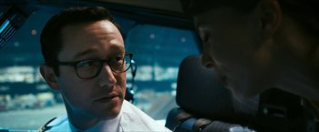 Movie still from “7500” (2019), directed by Patrick Vollrath – A man in a car talking to another man in the back seat; Close Up shot, Over the shoulder angle