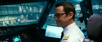 Movie still from “7500” (2019), directed by Patrick Vollrath – A man in a pilot's uniform looking at a computer screen; Close Up shot, Low angle