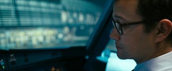 Movie still from “7500” (2019), directed by Patrick Vollrath – A man with glasses sitting in a car looking out the window; Close Up shot, Over the shoulder angle