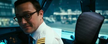 Movie still from “7500” (2019), directed by Patrick Vollrath – A man in a pilot's uniform sitting in a car; Close Up shot, Low angle