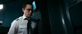 Movie still from “7500” (2019), directed by Patrick Vollrath – A man standing in front of a computer screen; Close Up shot, Low angle