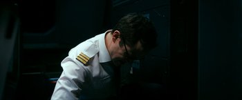 Movie still from “7500” (2019), directed by Patrick Vollrath – A man in a uniform is looking down at his glasses; Close Up shot, Low angle