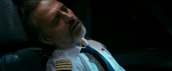 Movie still from “7500” (2019), directed by Patrick Vollrath – A man in a pilot's uniform is sleeping; Close Up shot, Overhead angle