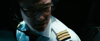 Movie still from “7500” (2019), directed by Patrick Vollrath – A person wearing glasses and wearing a uniform; Close Up shot, Low angle
