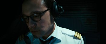 Movie still from “7500” (2019), directed by Patrick Vollrath – A man wearing headphones and a white dress shirt; Close Up shot, Low angle