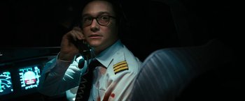 Movie still from “7500” (2019), directed by Patrick Vollrath – A man in a uniform talking on a phone; Close Up shot, High angle