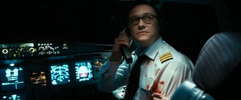 Movie still from “7500” (2019), directed by Patrick Vollrath – A man in a uniform talking on a phone; Close Up shot, Overhead angle