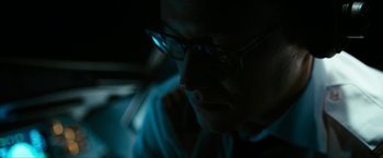 Movie still from “7500” (2019), directed by Patrick Vollrath – A man wearing glasses is looking at a computer screen; Close Up shot, Low angle