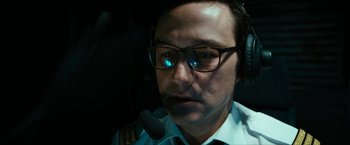 Movie still from “7500” (2019), directed by Patrick Vollrath – A man wearing a pilot's uniform and a headset; Close Up shot, High angle