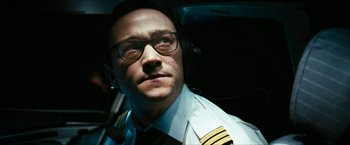 Movie still from “7500” (2019), directed by Patrick Vollrath – A man wearing a pilot's uniform and glasses; Close Up shot, Low angle