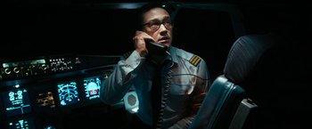 Movie still from “7500” (2019), directed by Patrick Vollrath – A man in a uniform talking on a phone; Medium shot, High angle