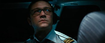 Movie still from “7500” (2019), directed by Patrick Vollrath – A man wearing a pilot's uniform looking up; Close Up shot, Low angle