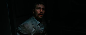 Movie still from “7500” (2019), directed by Patrick Vollrath – A man in a suit and tie with red lipstick on his face; Close Up shot, High angle