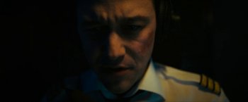 Movie still from “7500” (2019), directed by Patrick Vollrath – A person wearing a white shirt; Close Up shot, High angle