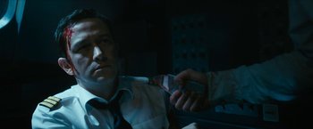 Movie still from “7500” (2019), directed by Patrick Vollrath – A man in a white dress shirt and tie holding a knife; Close Up shot, Low angle