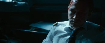 Movie still from “7500” (2019), directed by Patrick Vollrath – A man in a white shirt and a red tie; Close Up shot, Low angle