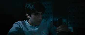 Movie still from “7500” (2019), directed by Patrick Vollrath – A man looking at his cell phone in the dark; Close Up shot, High angle