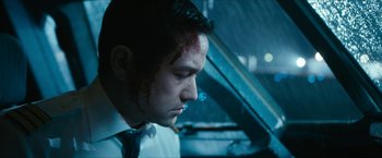 Movie still from “7500” (2019), directed by Patrick Vollrath – A man smoking a cigarette while wearing a tie; Close Up shot, Low angle