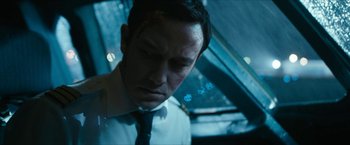 Movie still from “7500” (2019), directed by Patrick Vollrath – A person wearing a suit and tie; Close Up shot, High angle