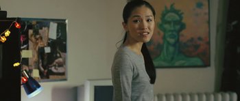 Movie still from “88 Minutes” (2007), directed by Jon Avnet – A woman standing in front of a painting in a room; Close Up shot, Over the shoulder angle