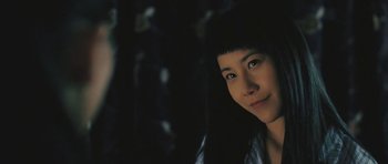 Movie still from “88 Minutes” (2007), directed by Jon Avnet – A woman with a black hair and green eyes looking at the camera; Close Up shot, Low angle